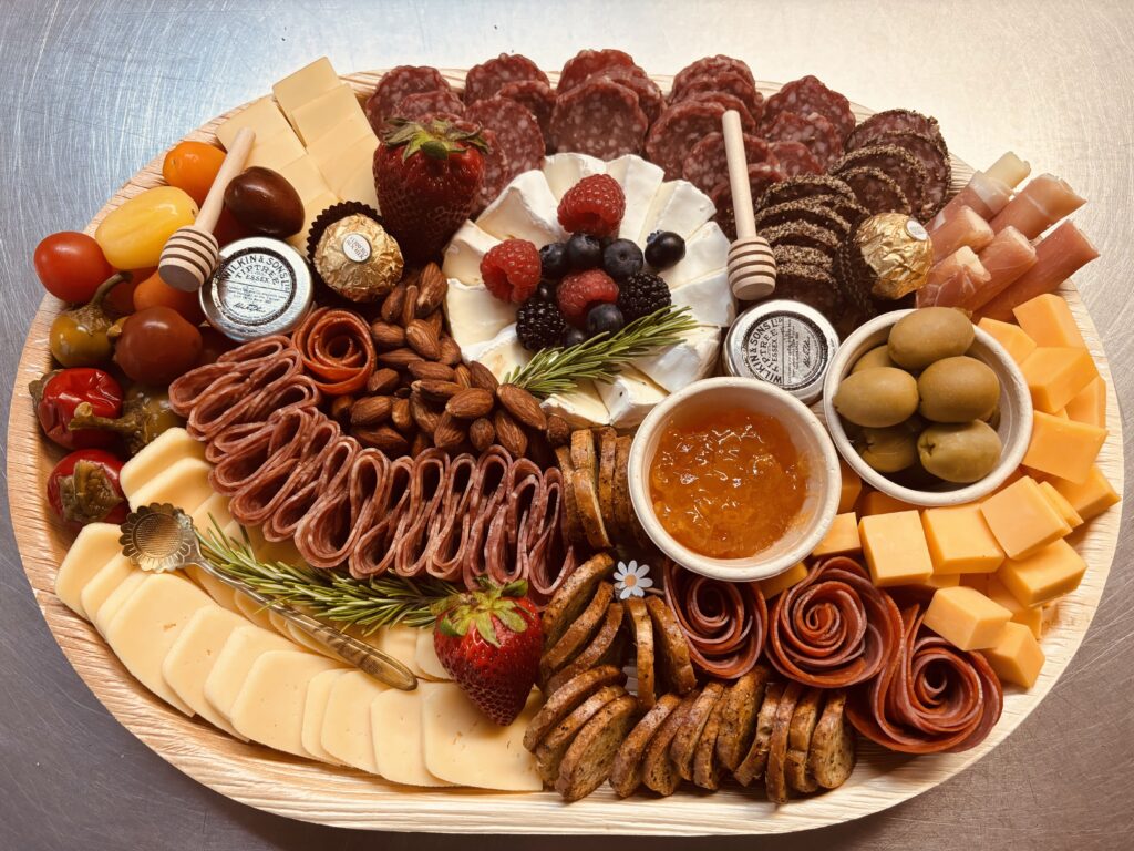 A gourmet charcuterie board featuring cured meats, cheeses, and various appetizers for a perfect dining experience.