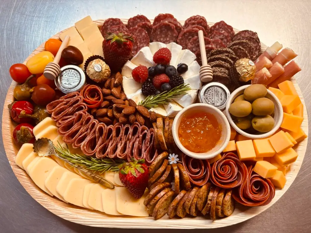 A gourmet charcuterie board featuring cured meats, cheeses, and various appetizers for a perfect dining experience.